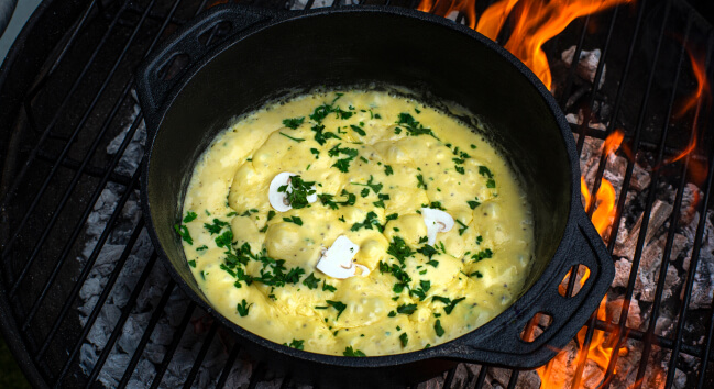 Creamy mushroom sauce in a pan, sprinkled with parsley.