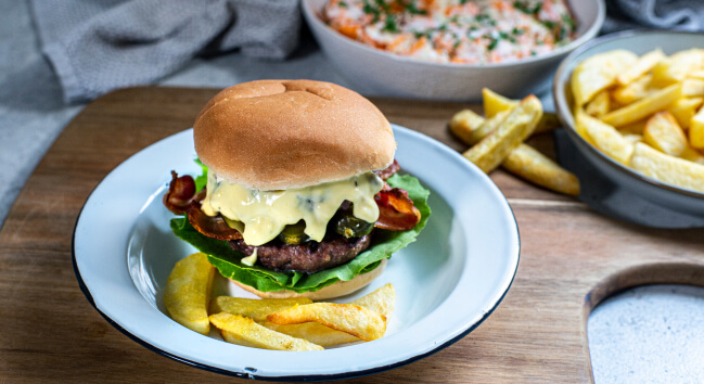 Delicious homemade burger with bacon, served on a plate.